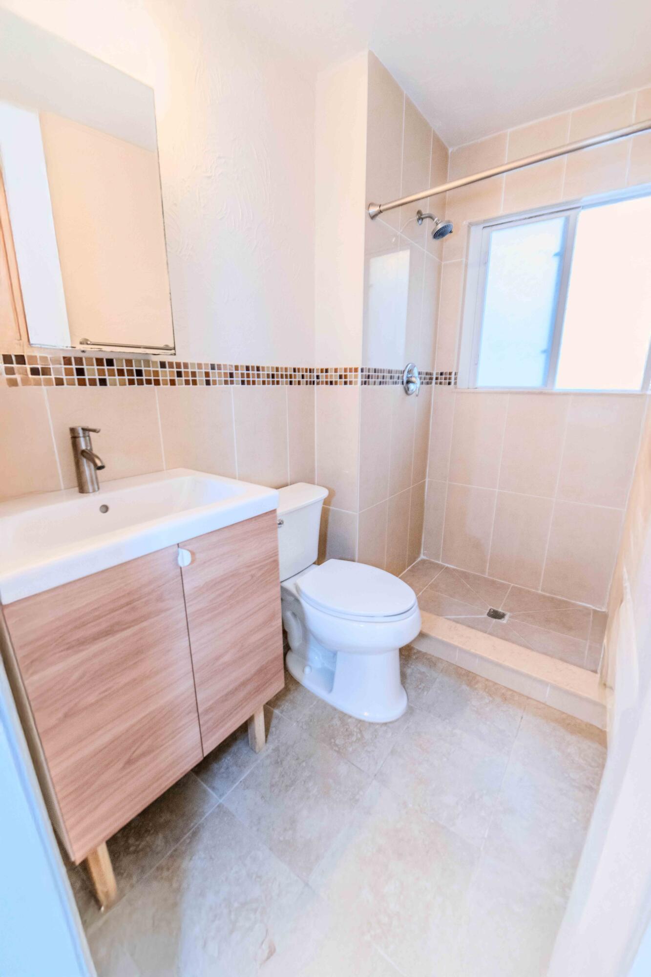 8111 Cedar Hollow Lane Boca Raton, FL 33433 - Photo 23 of 26 a bathroom with a sink a toilet and shower