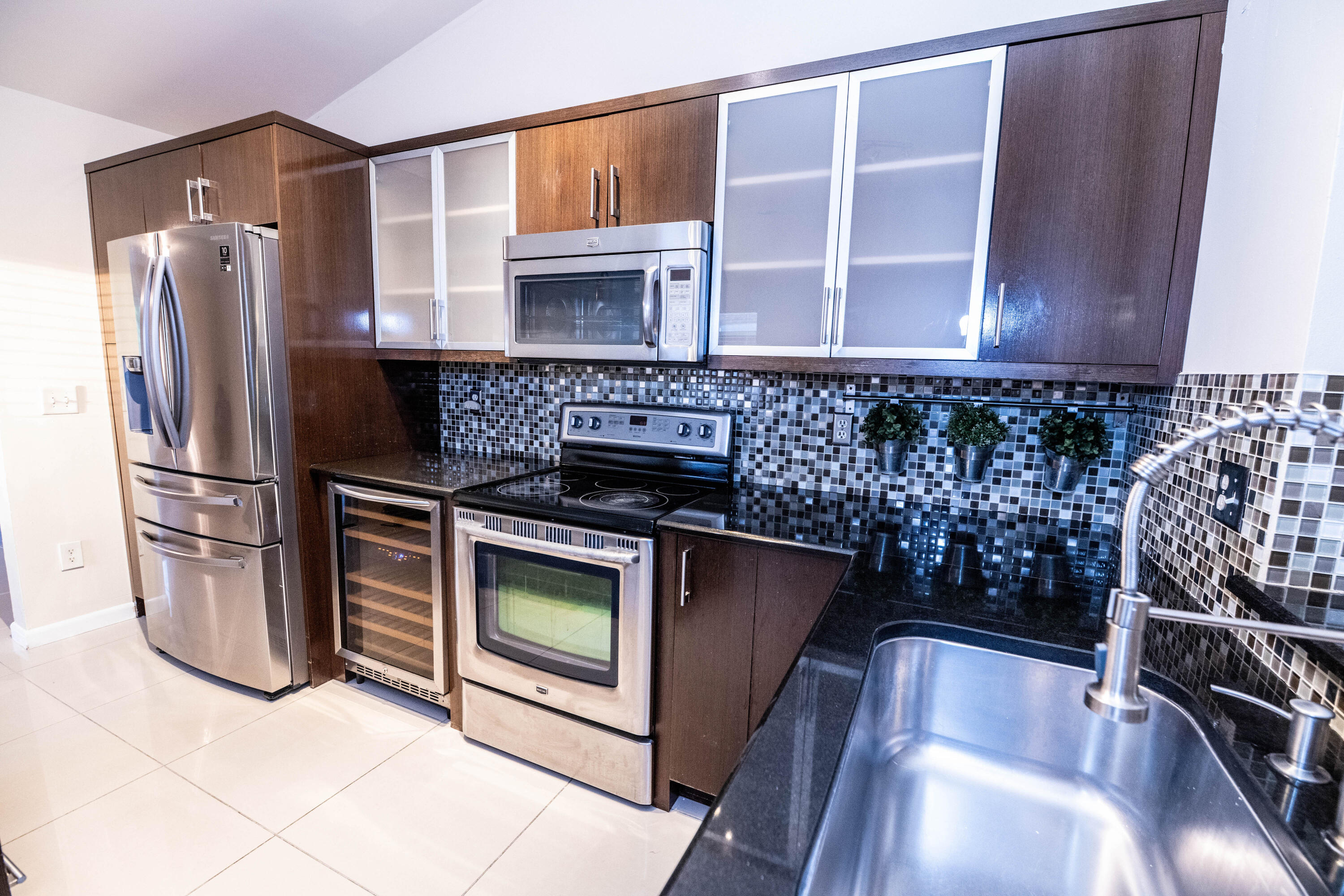 8111 Cedar Hollow Lane Boca Raton, FL 33433 - Photo 10 of 26 a kitchen with granite countertop a refrigerator stove and microwave