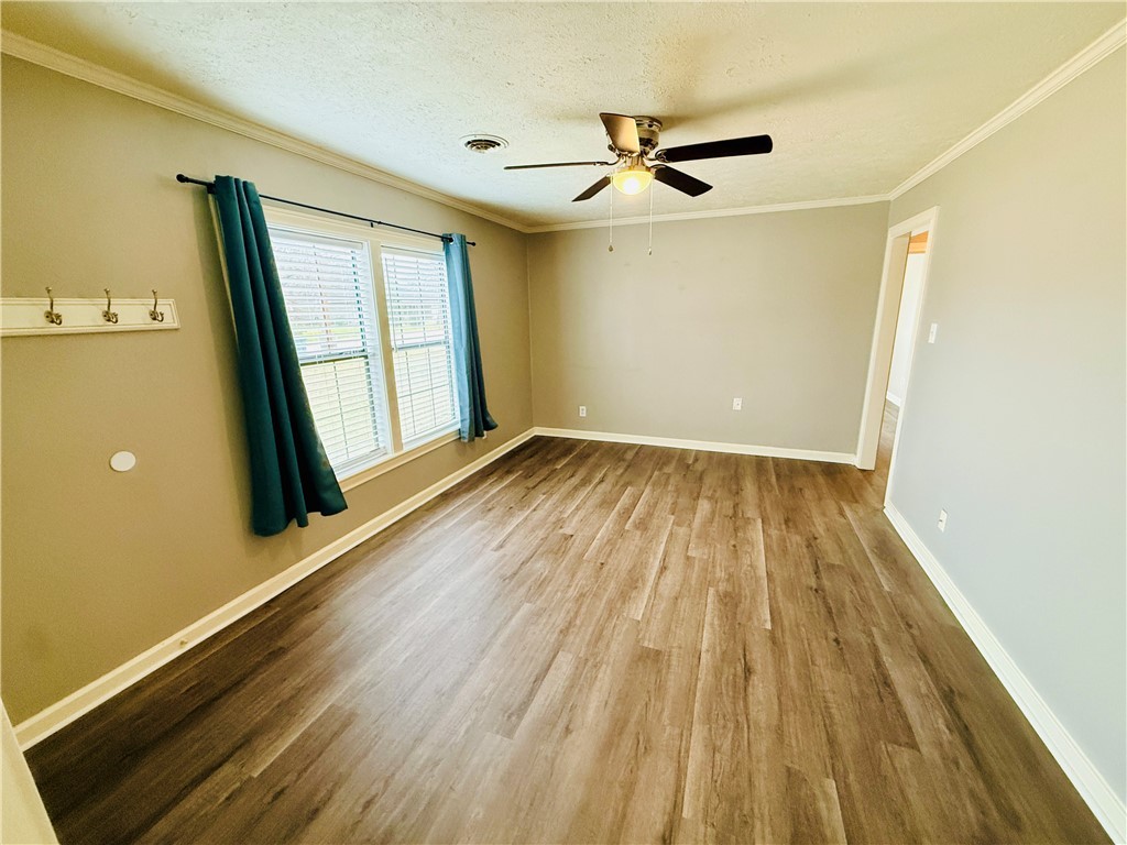 1413 Burt Street Bryan, TX 77802 - Photo 4 of 19 a view of empty room with wooden floor and fan