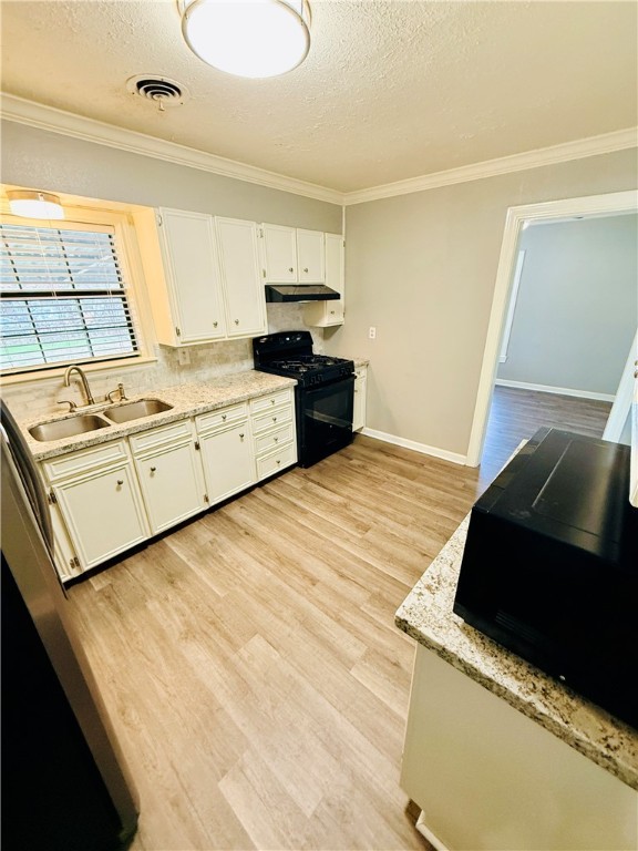 1413 Burt Street Bryan, TX 77802 - Photo 9 of 19 a kitchen with a stove and a refrigerator