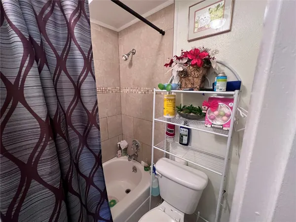 a bathroom with a toilet sink vanity tub and mirror
