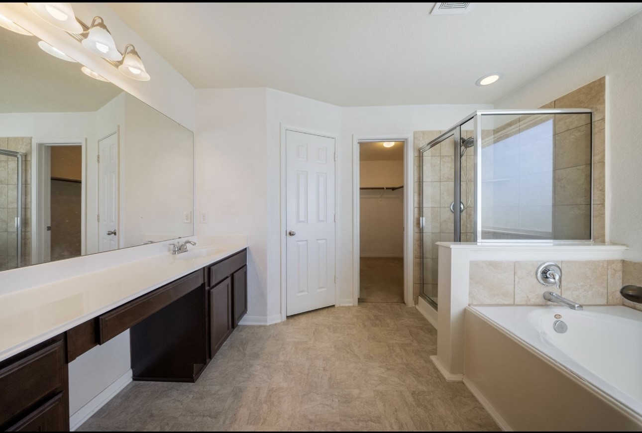 15003 Signal Ridge Way Cypress, TX 77429 - Photo 19 of 21 a bathroom with a tub sink and mirror