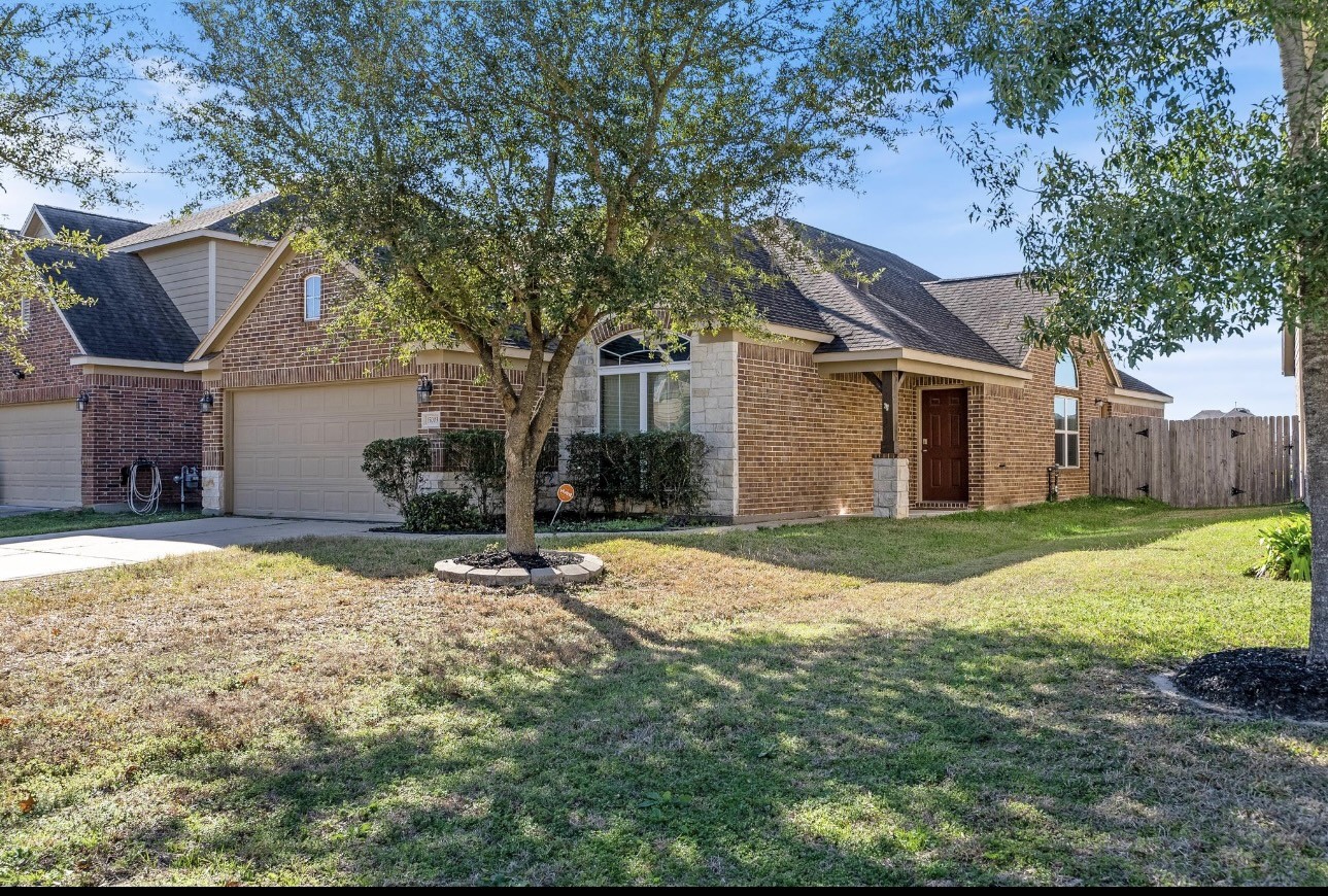 15003 Signal Ridge Way Cypress, TX 77429 - Photo 2 of 21 a backyard of a house with table and chairs under an umbrella