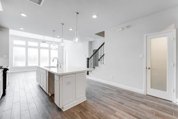 a kitchen with stainless steel appliances lots of counter top space and wooden floor