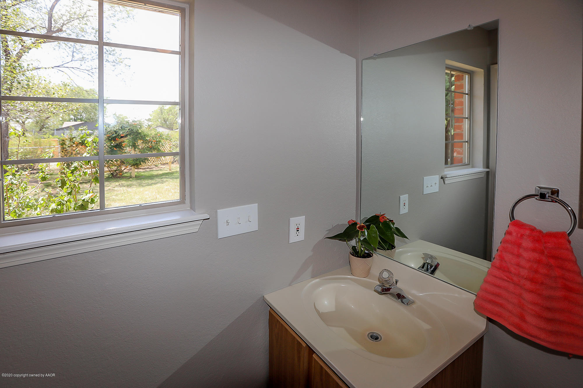 4110 South Hayden Street Amarillo, TX 79110 - Photo 14 of 28 a bathroom with a sink and a mirror