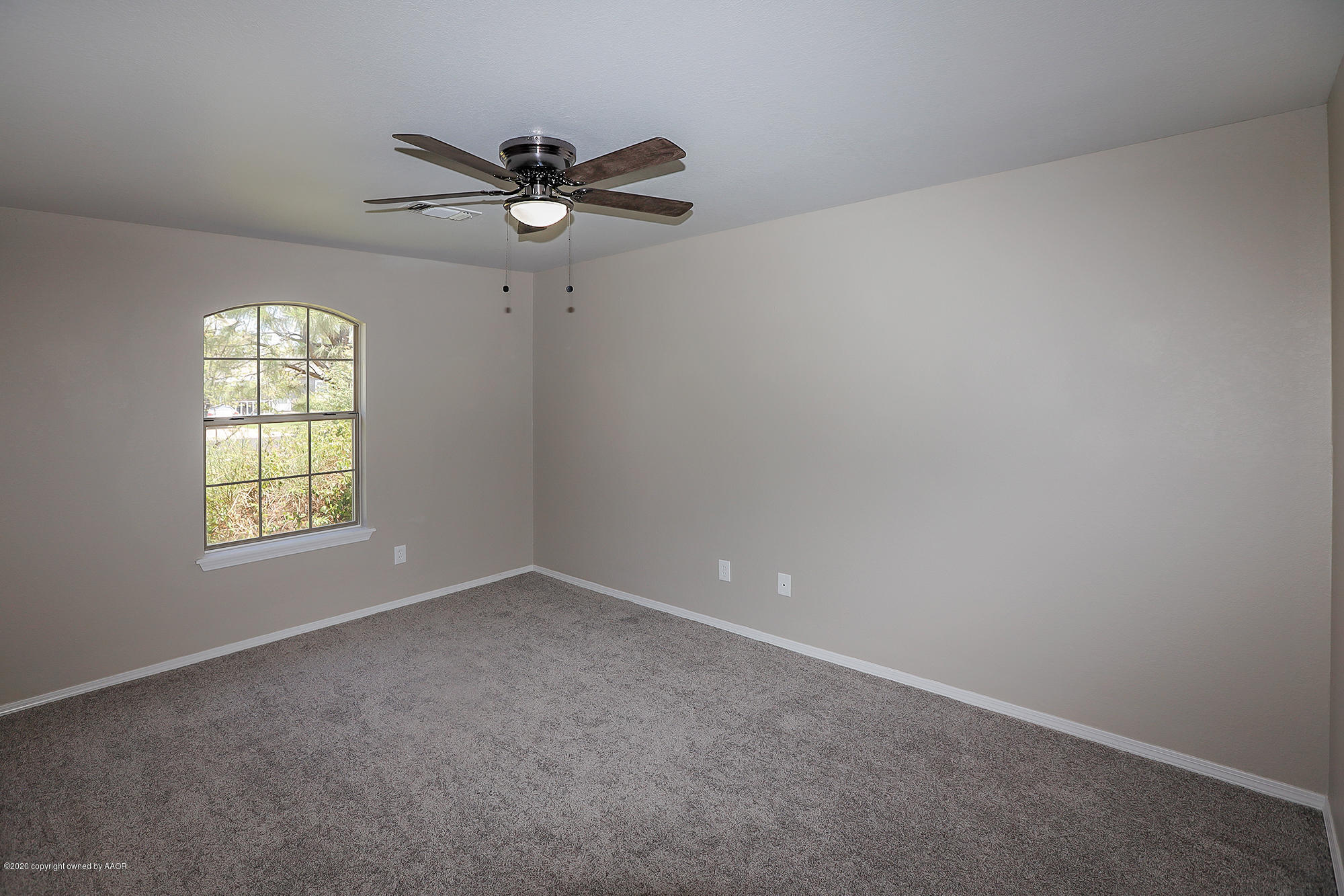4110 South Hayden Street Amarillo, TX 79110 - Photo 17 of 28 an empty room with a window and a fan