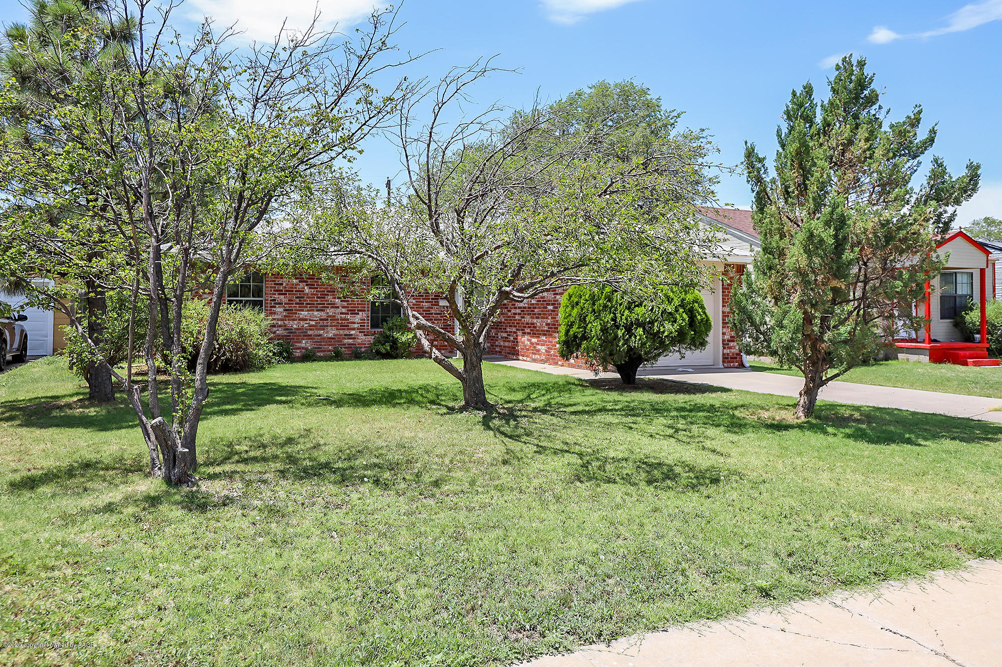 4110 South Hayden Street Amarillo, TX 79110 - Photo 2 of 28 a view of a yard with a tree