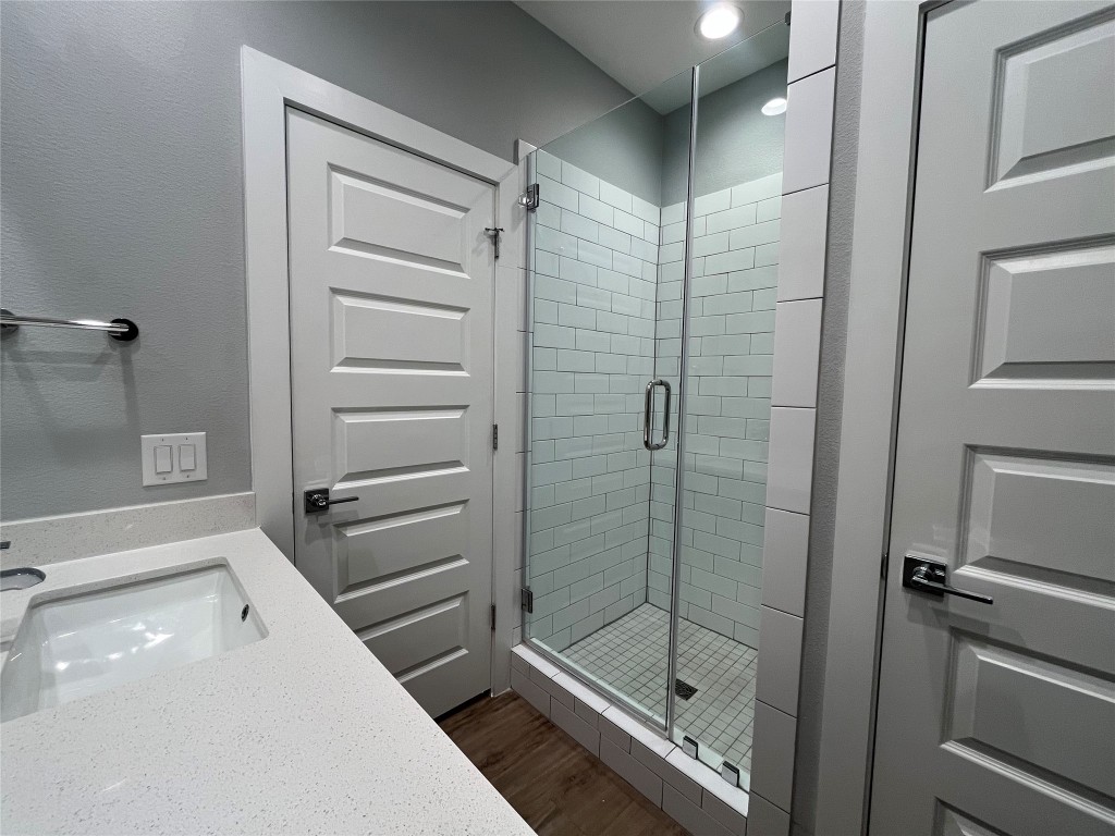 11402 Pastini Circle Manchaca, TX 78652 - Photo 17 of 21 a bathroom with a shower a mirror and a sink