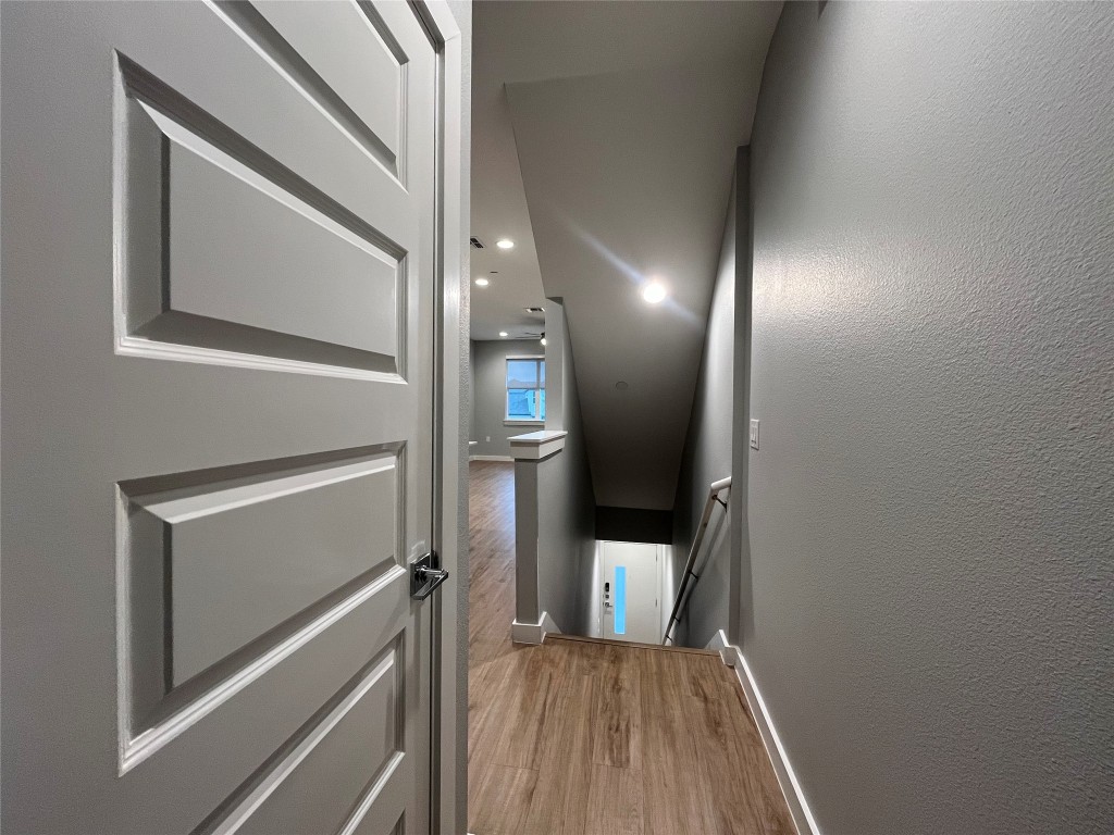 11402 Pastini Circle Manchaca, TX 78652 - Photo 6 of 21 a view of a hallway with wooden floor and staircase