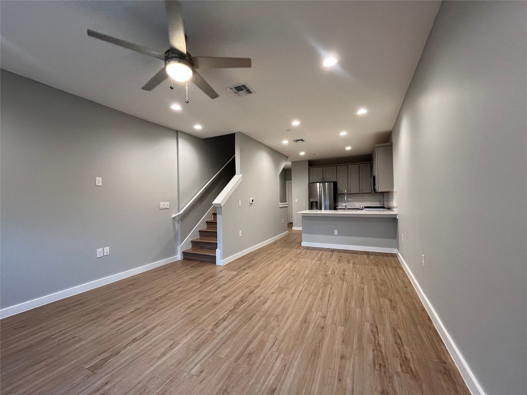 11402 Pastini Circle Manchaca, TX 78652 - Photo 10 of 21 a view of an empty room with wooden floor kitchen view and a window