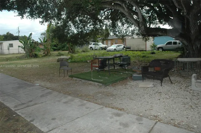 a view of backyard with outdoor seating and green space