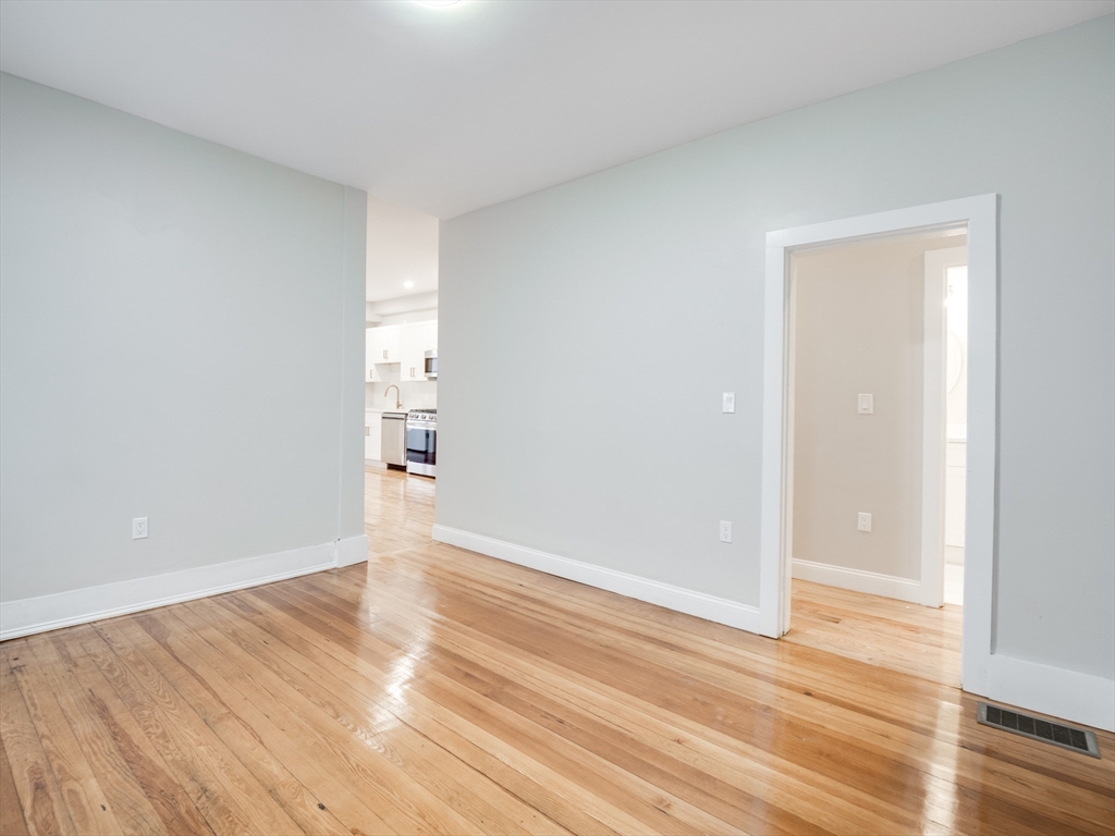 232 Saratoga Street, Unit 2 Boston, MA 02128 - Photo 5 of 9 wooden floor in an empty room