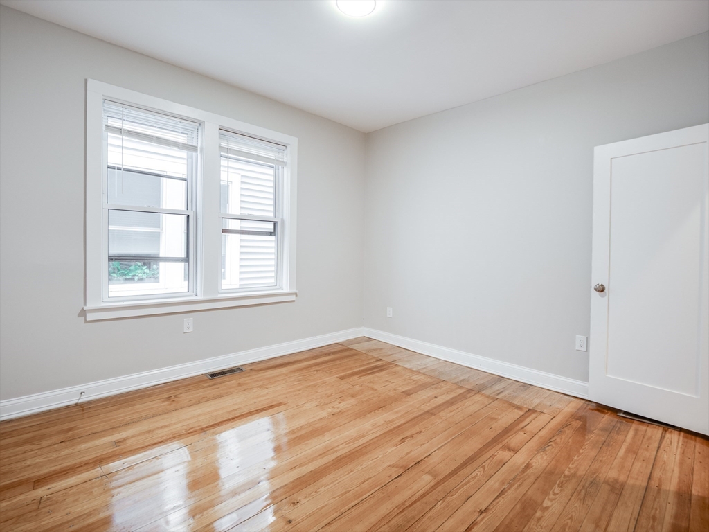 232 Saratoga Street, Unit 2 Boston, MA 02128 - Photo 7 of 9 a view of empty room with wooden floor and fan