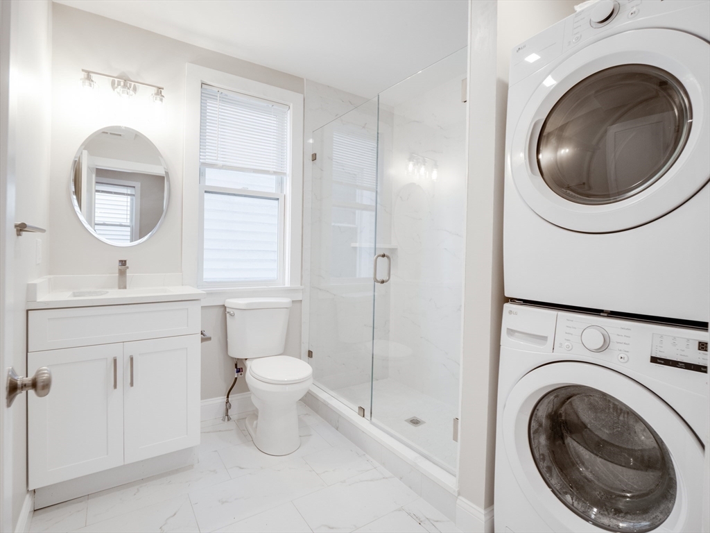 232 Saratoga Street, Unit 2 Boston, MA 02128 - Photo 9 of 9 a bathroom with a toilet sink and a mirror