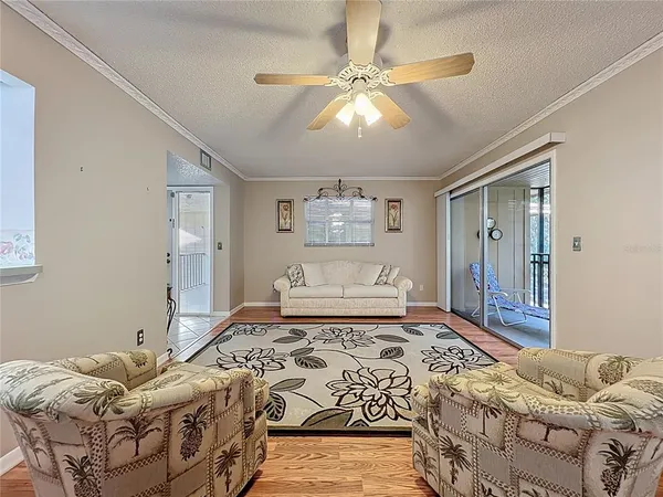 a view of a hallway with wooden floor and a floor to ceiling window