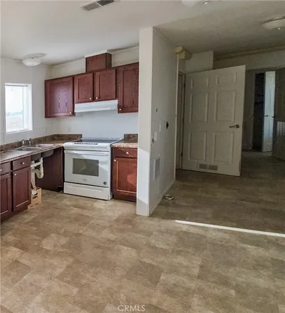 a view of kitchen with stainless steel appliances granite countertop a stove top oven a sink and dishwasher