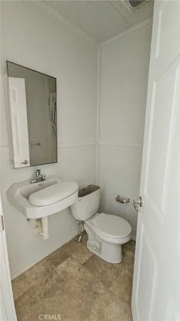a bathroom with a sink a toilet and mirror