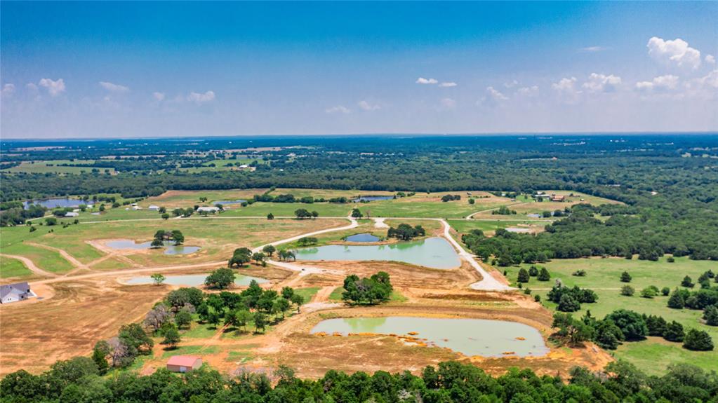 1789 Brumelow Road Whitesboro, TX 76273 - Photo 21 of 30 Expansive aerial landscape featuring multiple bodies of water, undeveloped land, and distant structures