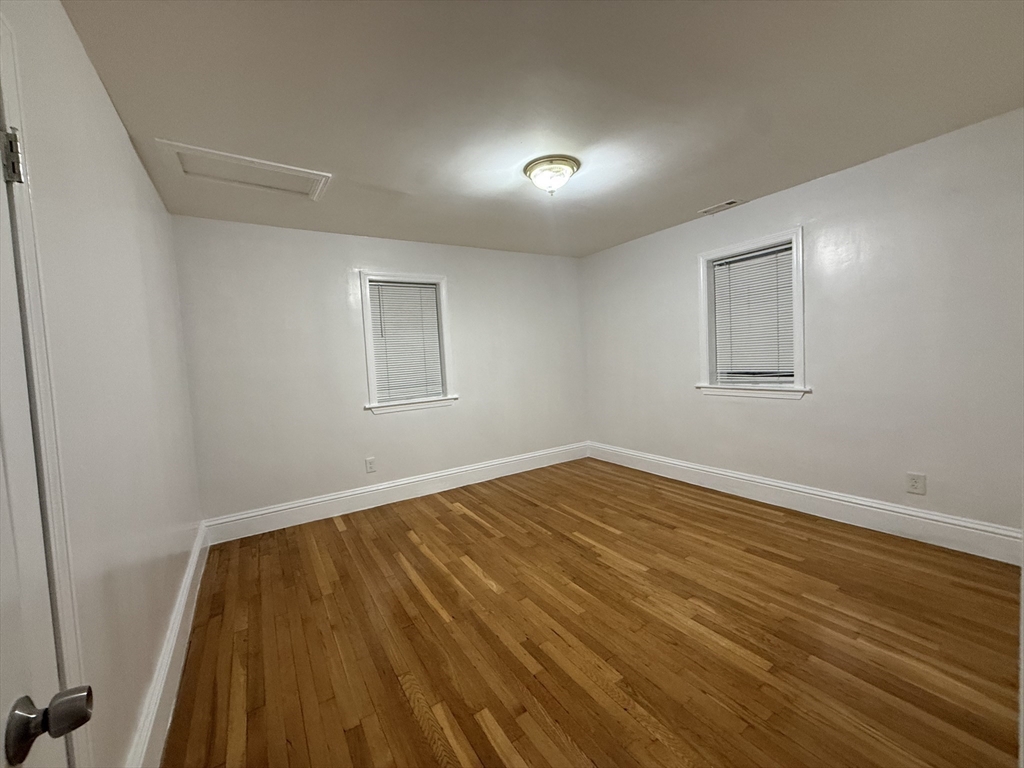 23 Myrtle Street, Unit 2 Quincy, MA 02171 - Photo 5 of 12 a view of empty room with wooden floor
