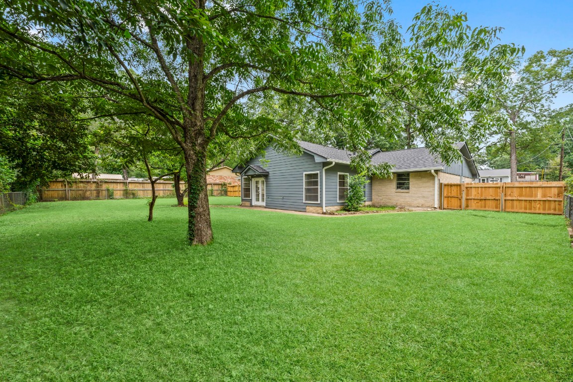 209 Summit Drive Conroe, TX 77303 - Photo 19 of 21 a view of house with a backyard