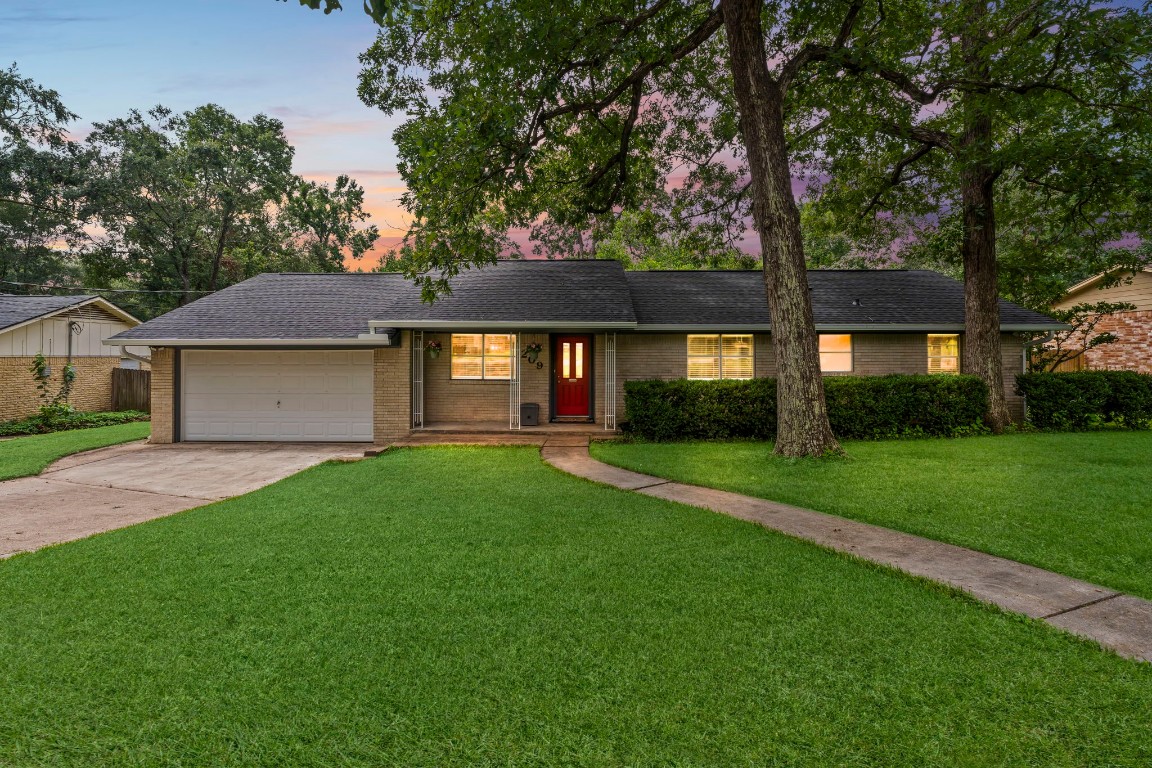 209 Summit Drive Conroe, TX 77303 - Photo 21 of 21 a front view of a house with a yard and garage