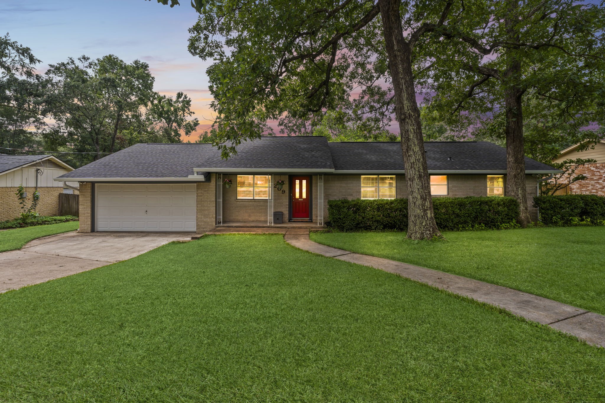209 Summit Drive Conroe, TX 77303 - Photo 21 of 21 a front view of a house with a yard and green space
