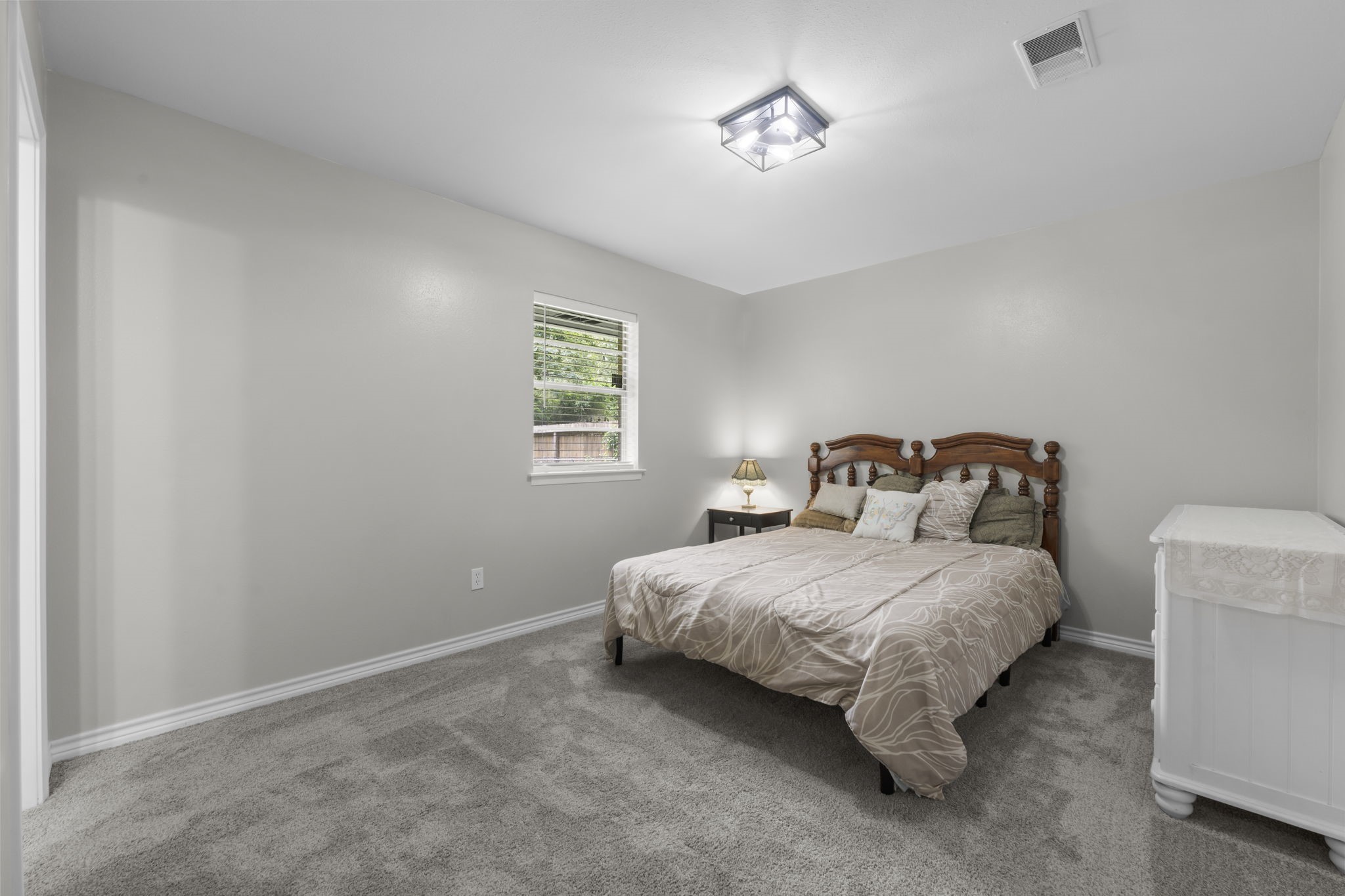 209 Summit Drive Conroe, TX 77303 - Photo 7 of 21 a bedroom with a bed and a window