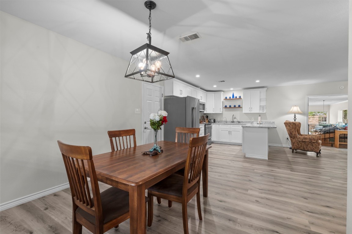 209 Summit Drive Conroe, TX 77303 - Photo 9 of 21 a view of a dining room with furniture and wooden floor