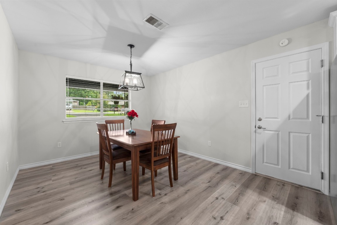 209 Summit Drive Conroe, TX 77303 - Photo 10 of 21 a view of a dining room with furniture window and wooden floor