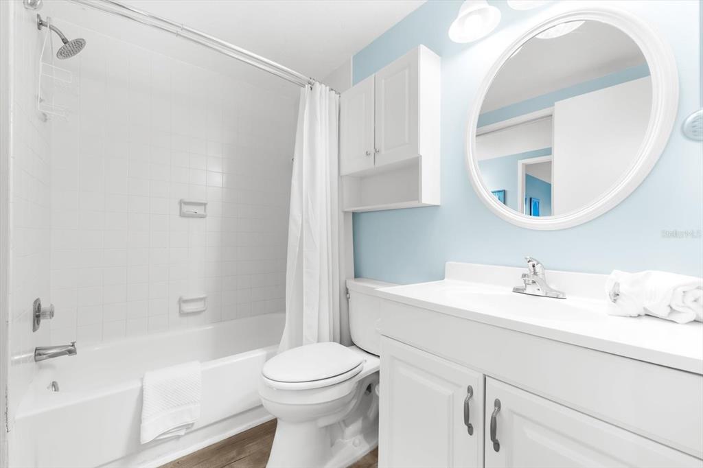 102 68th Street, Unit 102 Holmes Beach, FL 34217 - Photo 11 of 48 a bathroom with a sink a toilet and a mirror