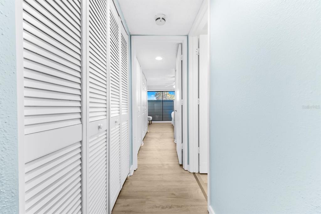 102 68th Street, Unit 102 Holmes Beach, FL 34217 - Photo 14 of 48 a view of a hallway with wooden floor and staircase