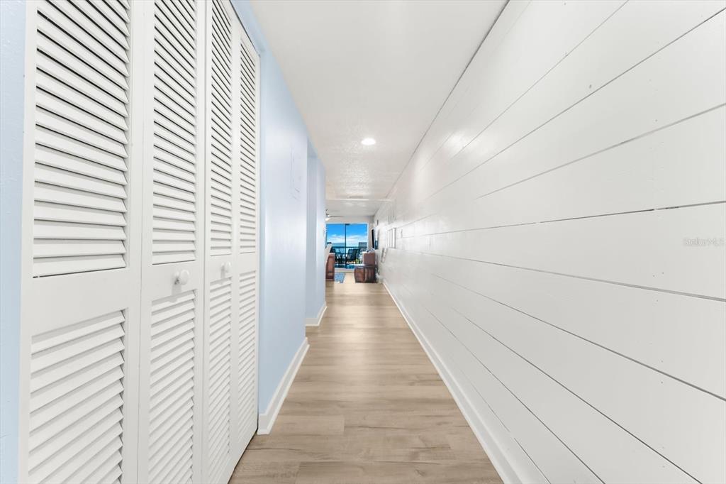 102 68th Street, Unit 102 Holmes Beach, FL 34217 - Photo 15 of 48 a view of a hallway with wooden floor and a large window