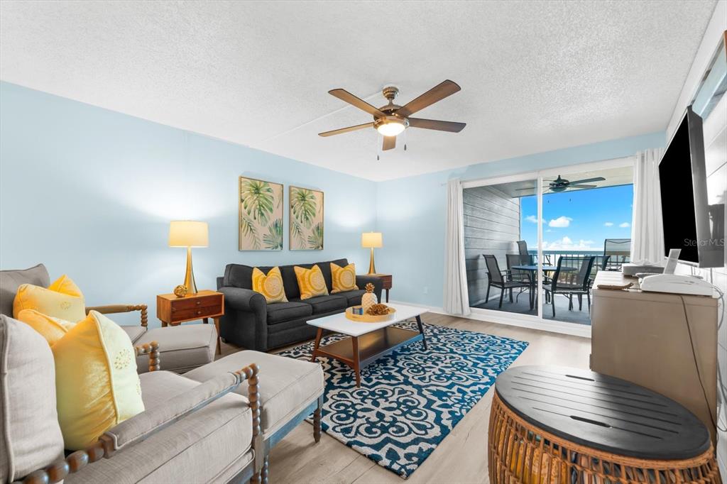 102 68th Street, Unit 102 Holmes Beach, FL 34217 - Photo 20 of 48 a living room with furniture and a wooden floor