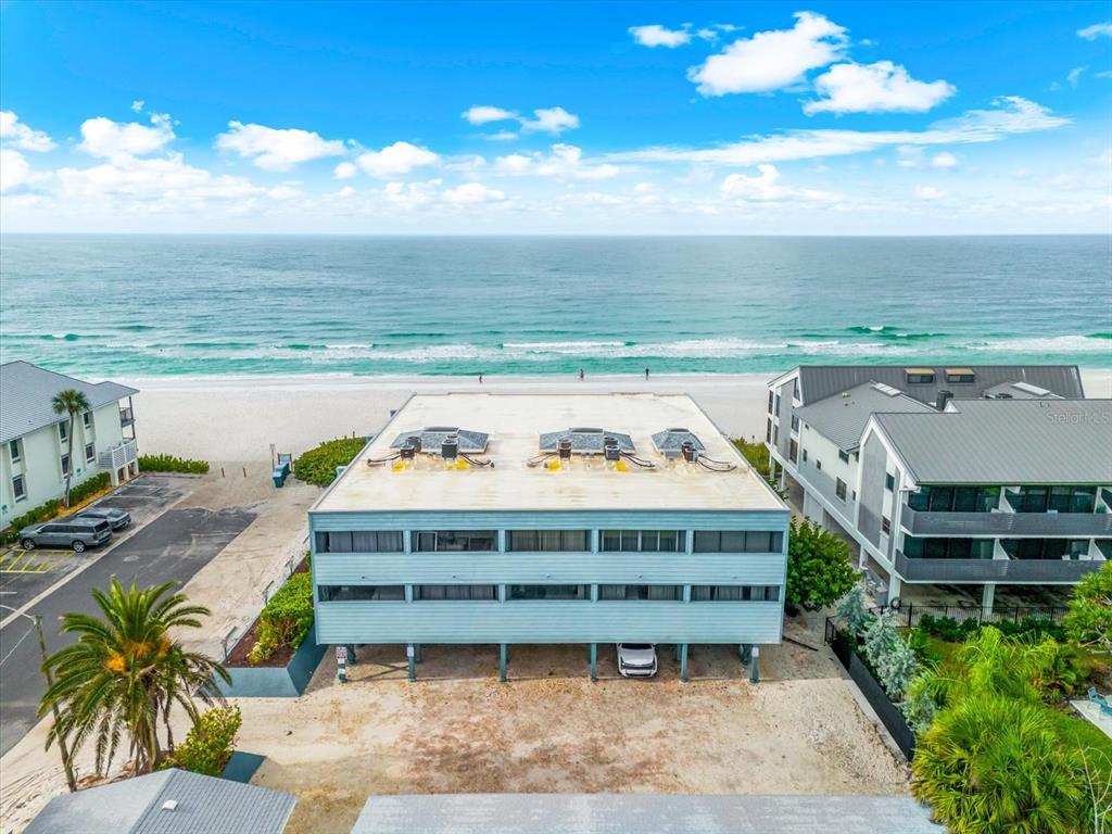 102 68th Street, Unit 102 Holmes Beach, FL 34217 - Photo 2 of 48 a view of a swimming pool with furniture