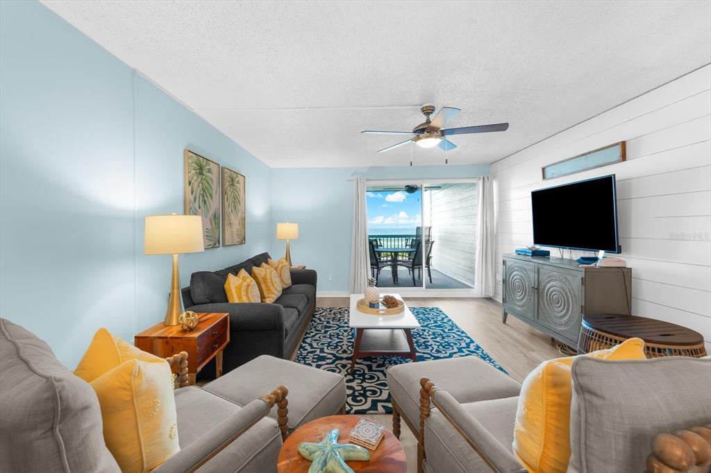 102 68th Street, Unit 102 Holmes Beach, FL 34217 - Photo 21 of 48 a living room with furniture and a flat screen tv