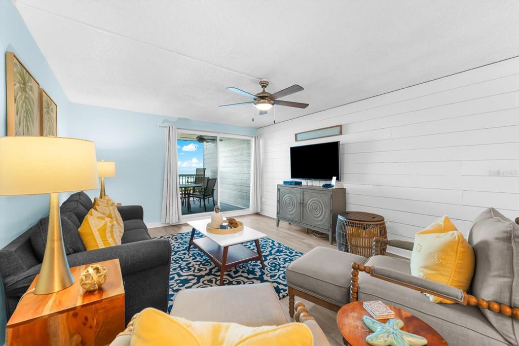 102 68th Street, Unit 102 Holmes Beach, FL 34217 - Photo 22 of 48 a living room with furniture and a flat screen tv