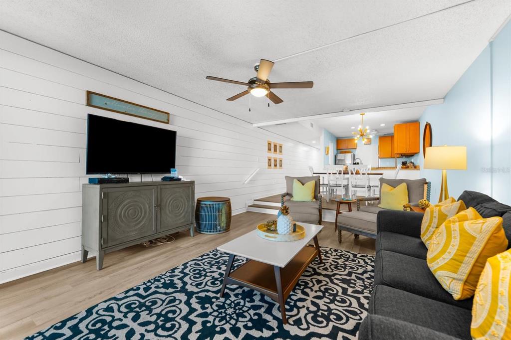 102 68th Street, Unit 102 Holmes Beach, FL 34217 - Photo 23 of 48 a living room with furniture a flat screen tv and kitchen view