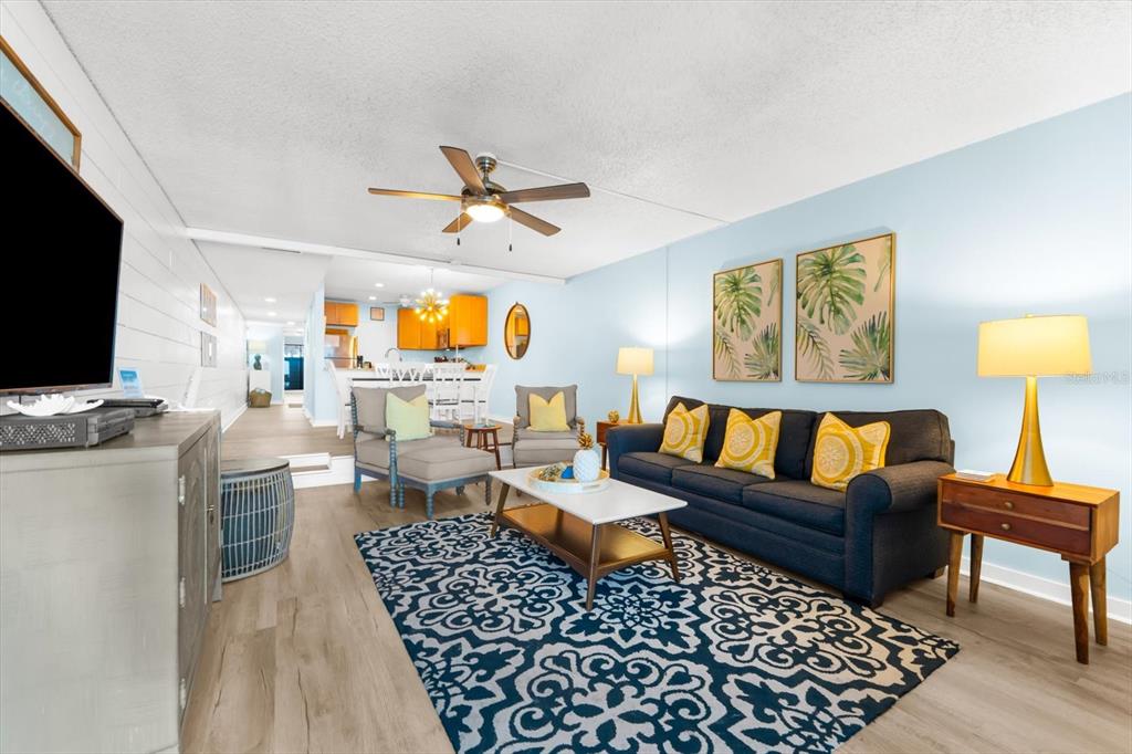 102 68th Street, Unit 102 Holmes Beach, FL 34217 - Photo 24 of 48 a living room with furniture and a flat screen tv