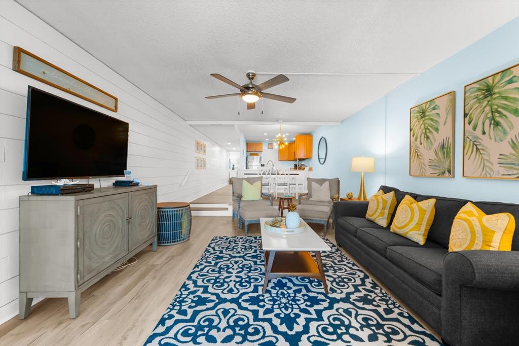 102 68th Street, Unit 102 Holmes Beach, FL 34217 - Photo 25 of 48 a living room with furniture and a flat screen tv