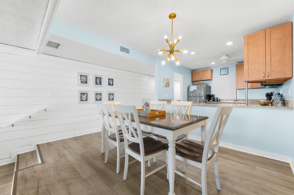 102 68th Street, Unit 102 Holmes Beach, FL 34217 - Photo 26 of 48 a view of a dining room with furniture and wooden floor