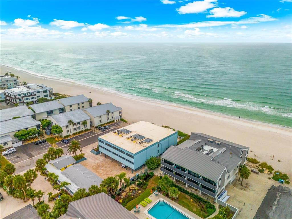 102 68th Street, Unit 102 Holmes Beach, FL 34217 - Photo 40 of 48 an aerial view of beach and ocean