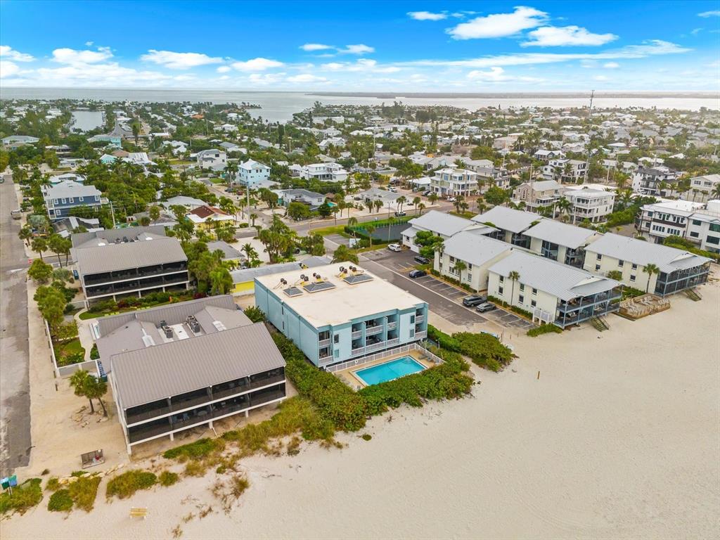 102 68th Street, Unit 102 Holmes Beach, FL 34217 - Photo 41 of 48 an aerial view of residential houses with outdoor space