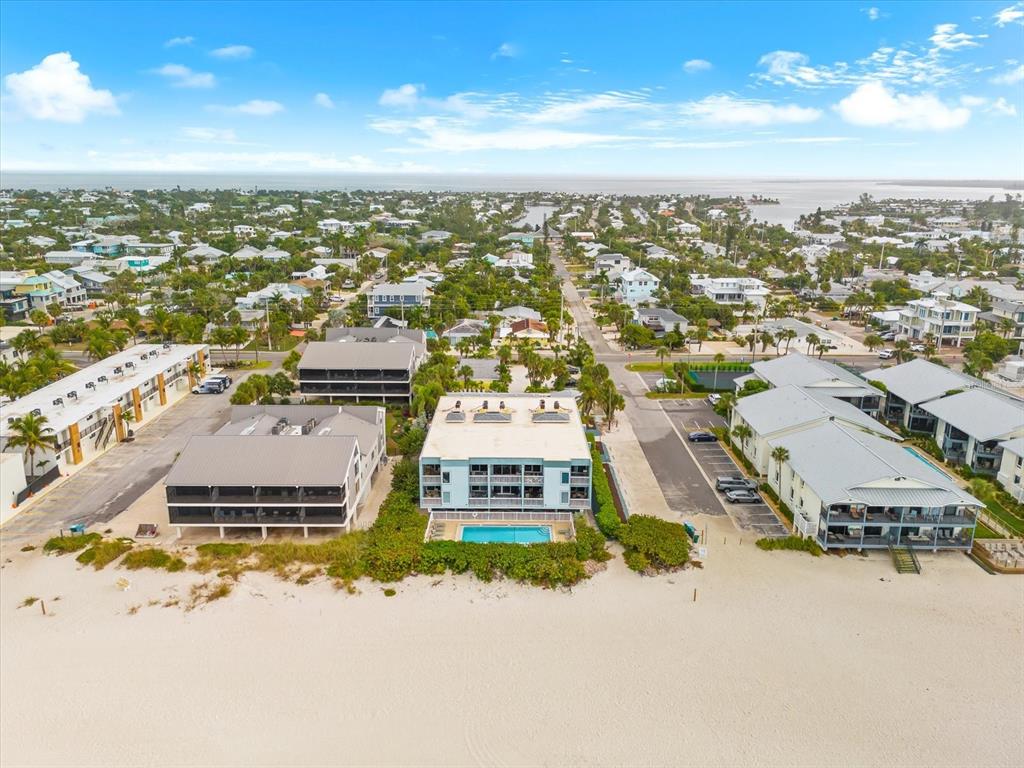 102 68th Street, Unit 102 Holmes Beach, FL 34217 - Photo 42 of 48 an aerial view of residential houses with outdoor space