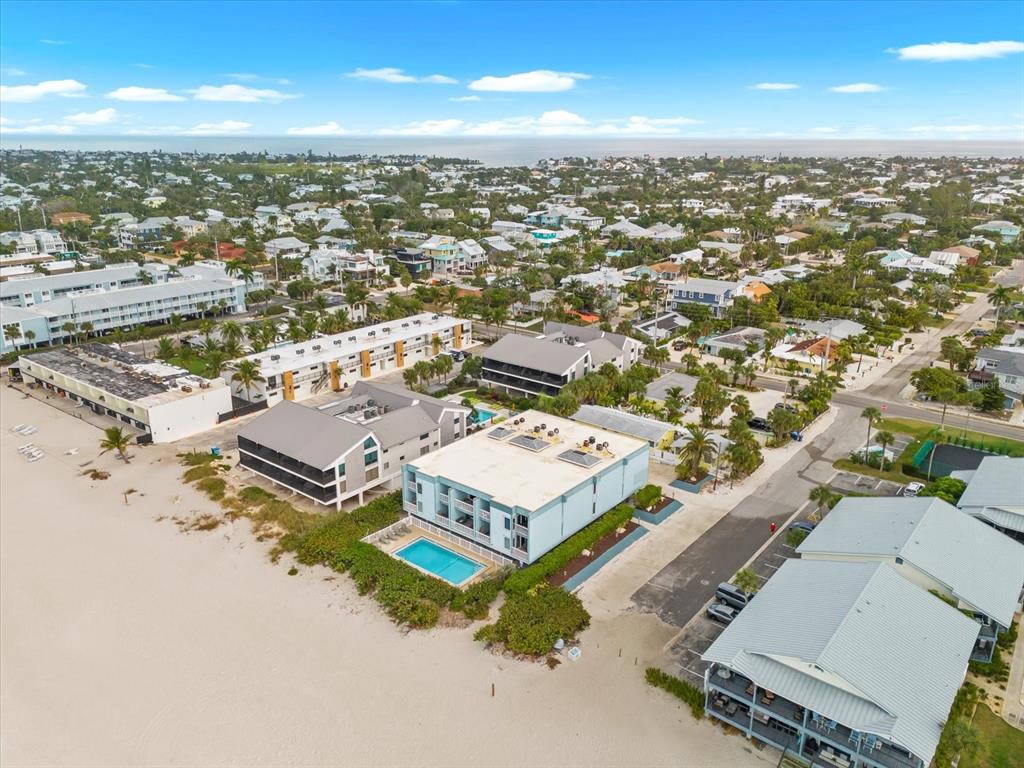 102 68th Street, Unit 102 Holmes Beach, FL 34217 - Photo 45 of 48 an aerial view of residential houses with outdoor space