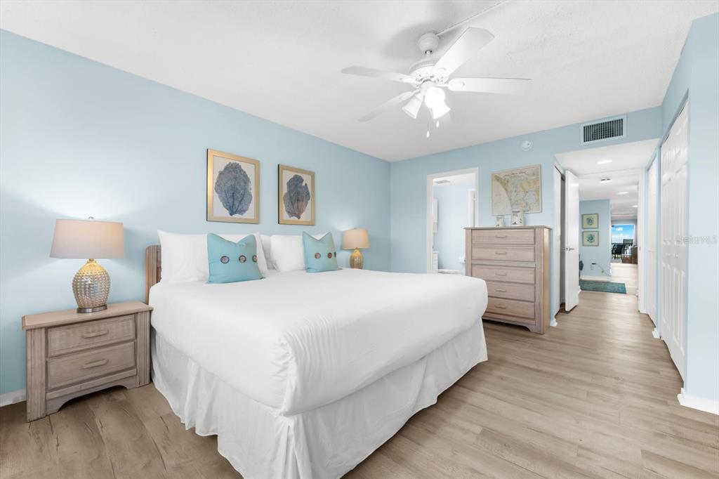 102 68th Street, Unit 102 Holmes Beach, FL 34217 - Photo 5 of 48 a bedroom with bed and wooden floor