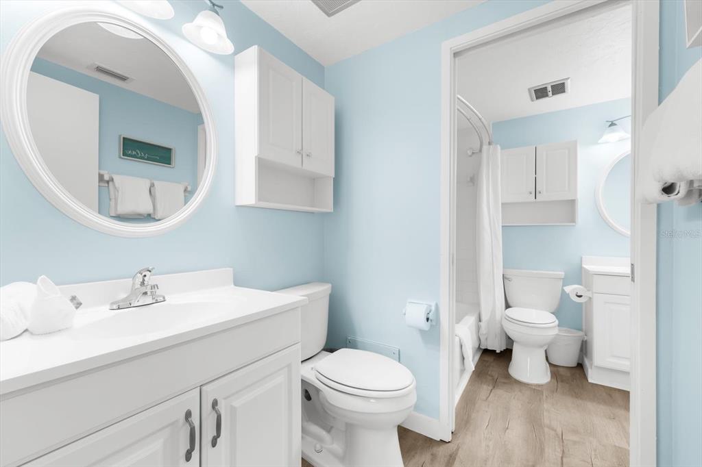 102 68th Street, Unit 102 Holmes Beach, FL 34217 - Photo 10 of 48 a bathroom with a toilet sink and mirror