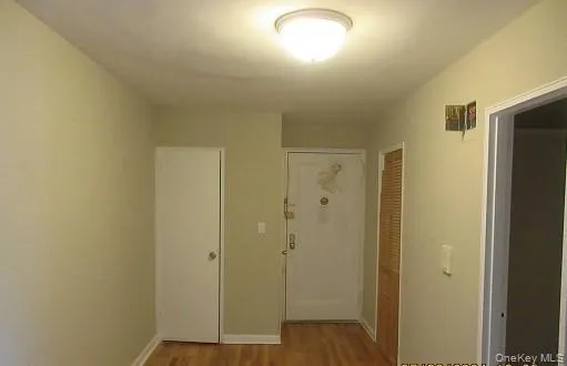 a view of a hallway with wooden floor