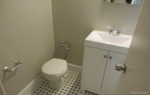 a bathroom with a sink toilet and a mirror