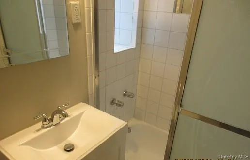 a bathroom with a sink and shower