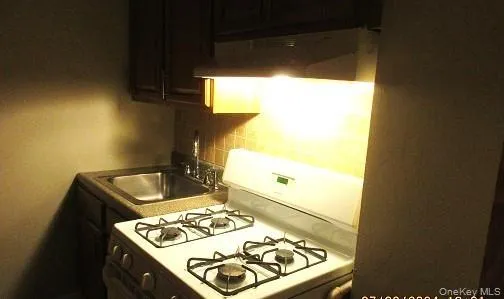 a kitchen with a sink and a stove top oven